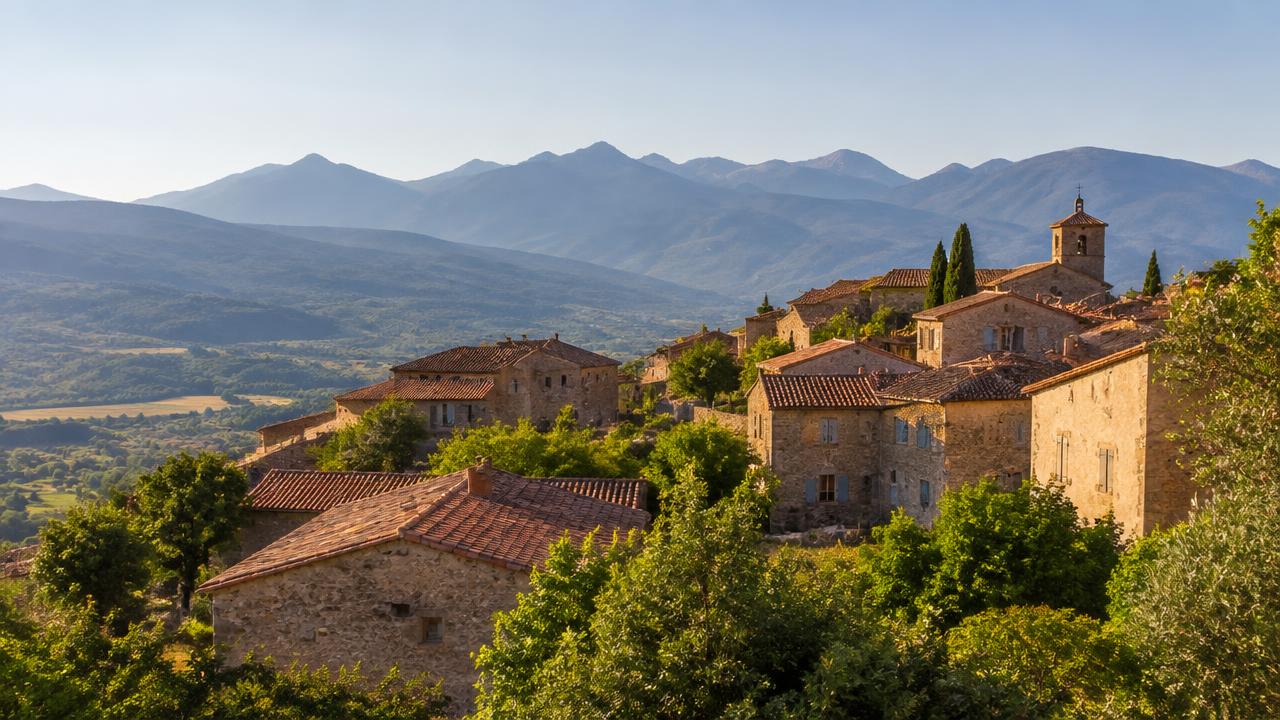 Sunlit stone village on a hillside in Occitanie